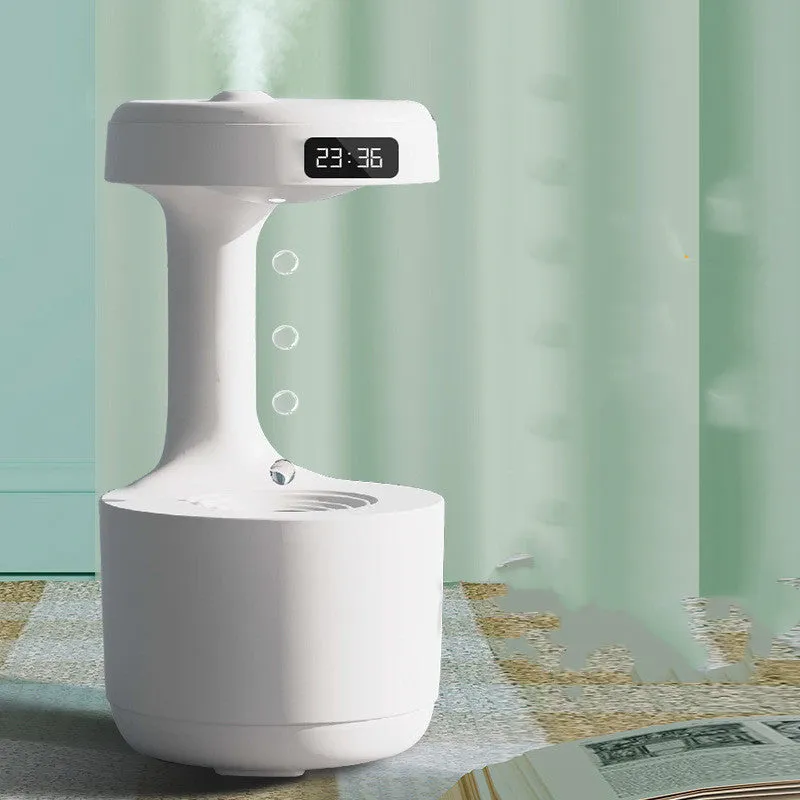 Bedroom anti-gravity humidifier with clock and backflow aroma diffuser in white plastic on desk with LED display