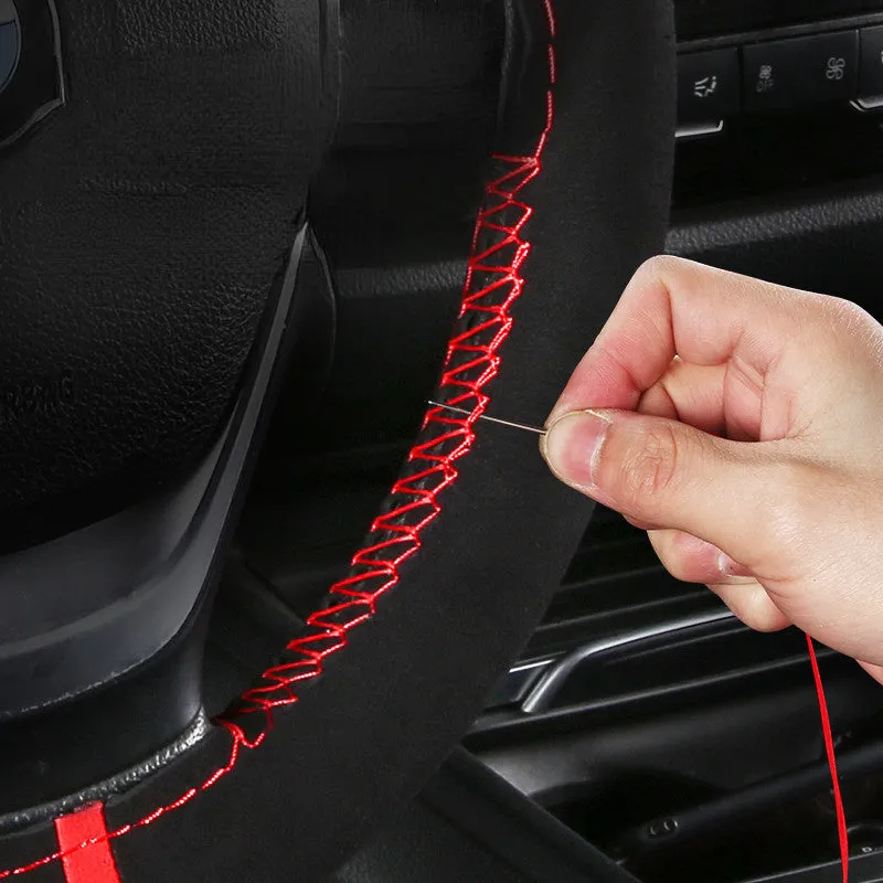 Black microfiber steering wheel cover with contrasting red stitch on 38cm diameter wheel
