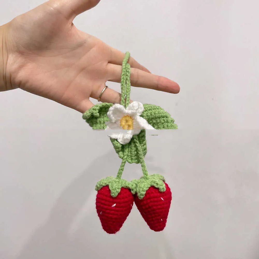 Handmade strawberry-shaped car pendant made with knitted cotton and hemp wool.