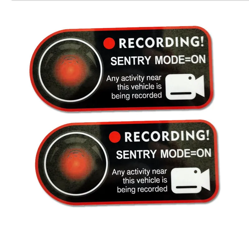 Pair of Tesla Sentry Mode warning stickers showing English text on PVC material