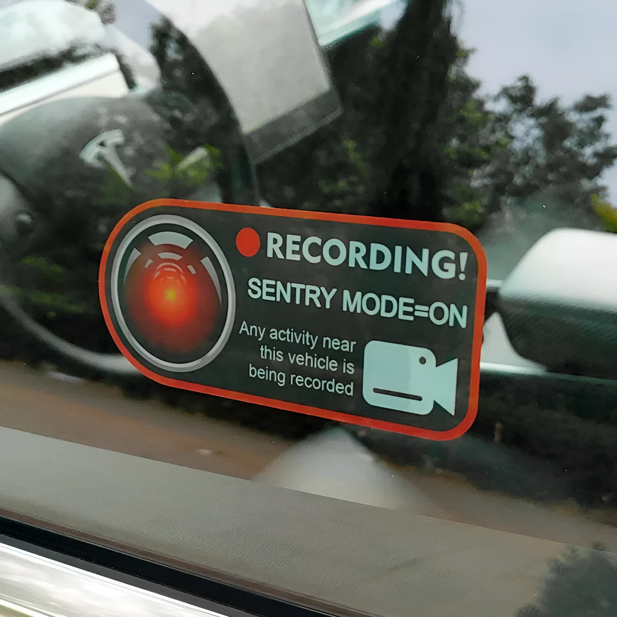 Pair of Tesla Sentry Mode warning stickers showing English text on PVC material
