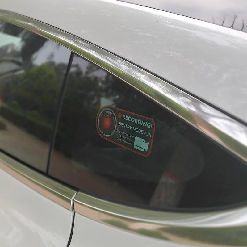 Pair of Tesla Sentry Mode warning stickers showing English text on PVC material