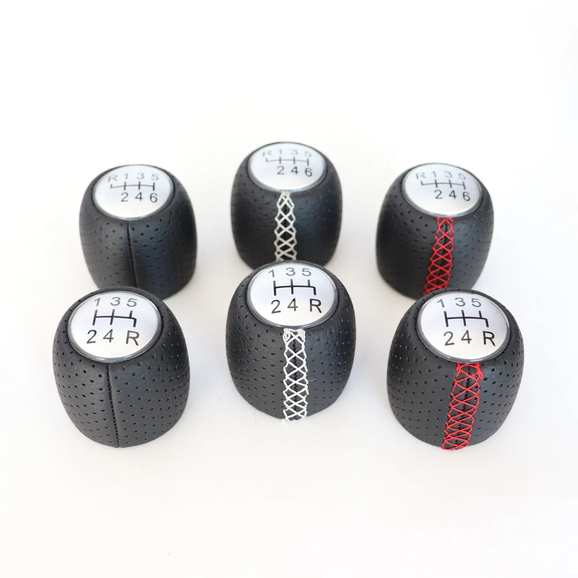 Sewn wrapped perforated leather gear knob for Alpha car in black, red, or white with matte or silver cover.