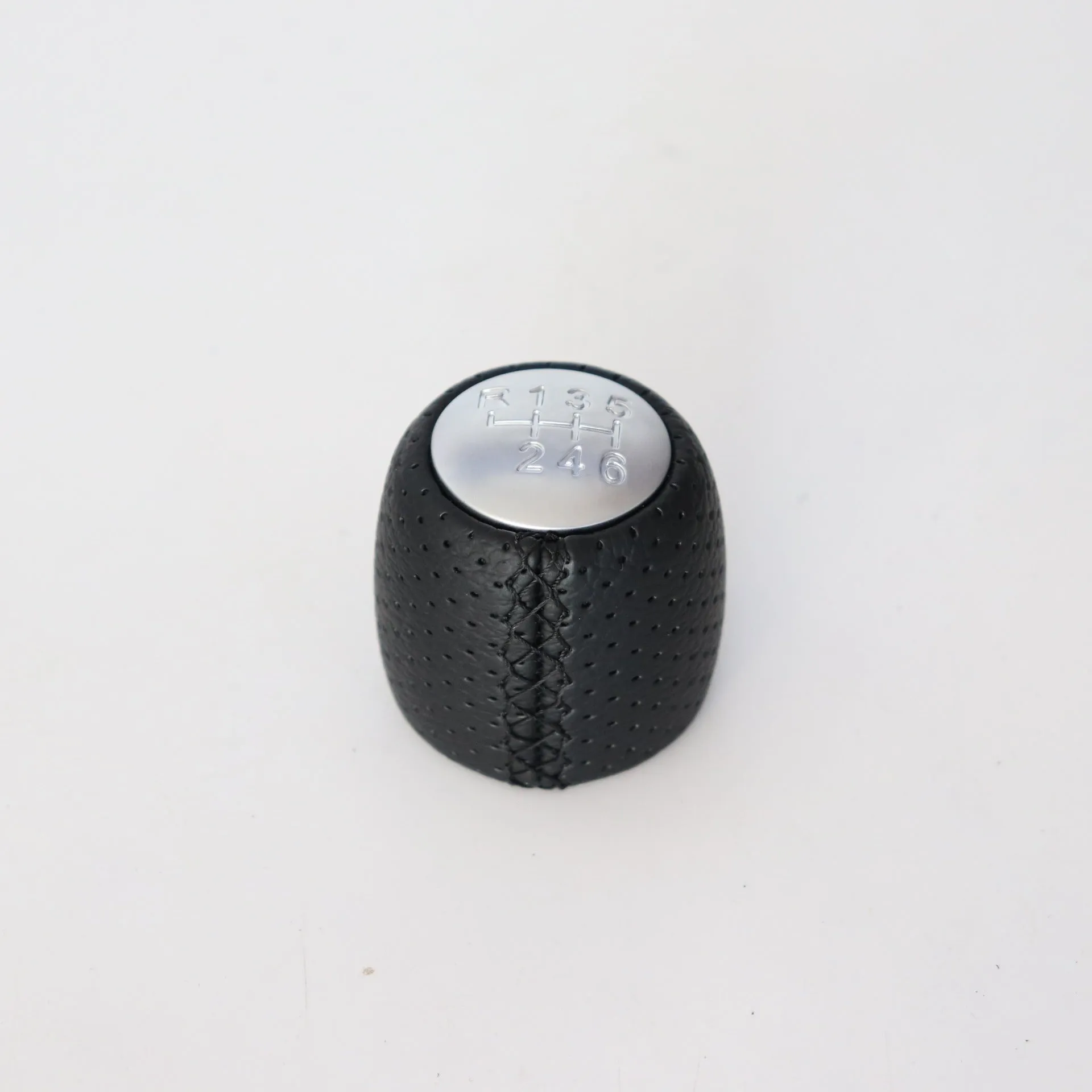 Sewn wrapped perforated leather gear knob for Alpha car in black, red, or white with matte or silver cover.