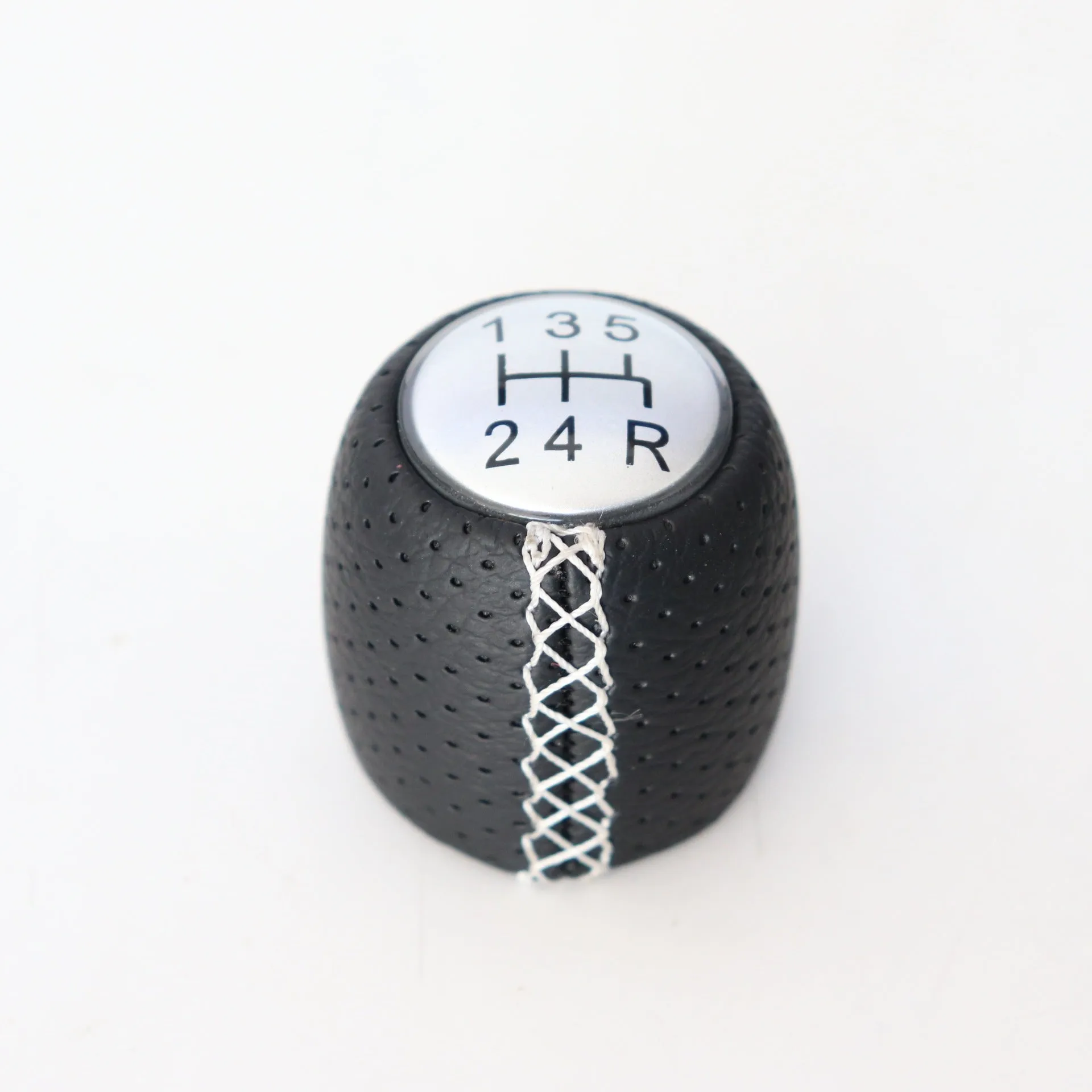 Sewn wrapped perforated leather gear knob for Alpha car in black, red, or white with matte or silver cover.