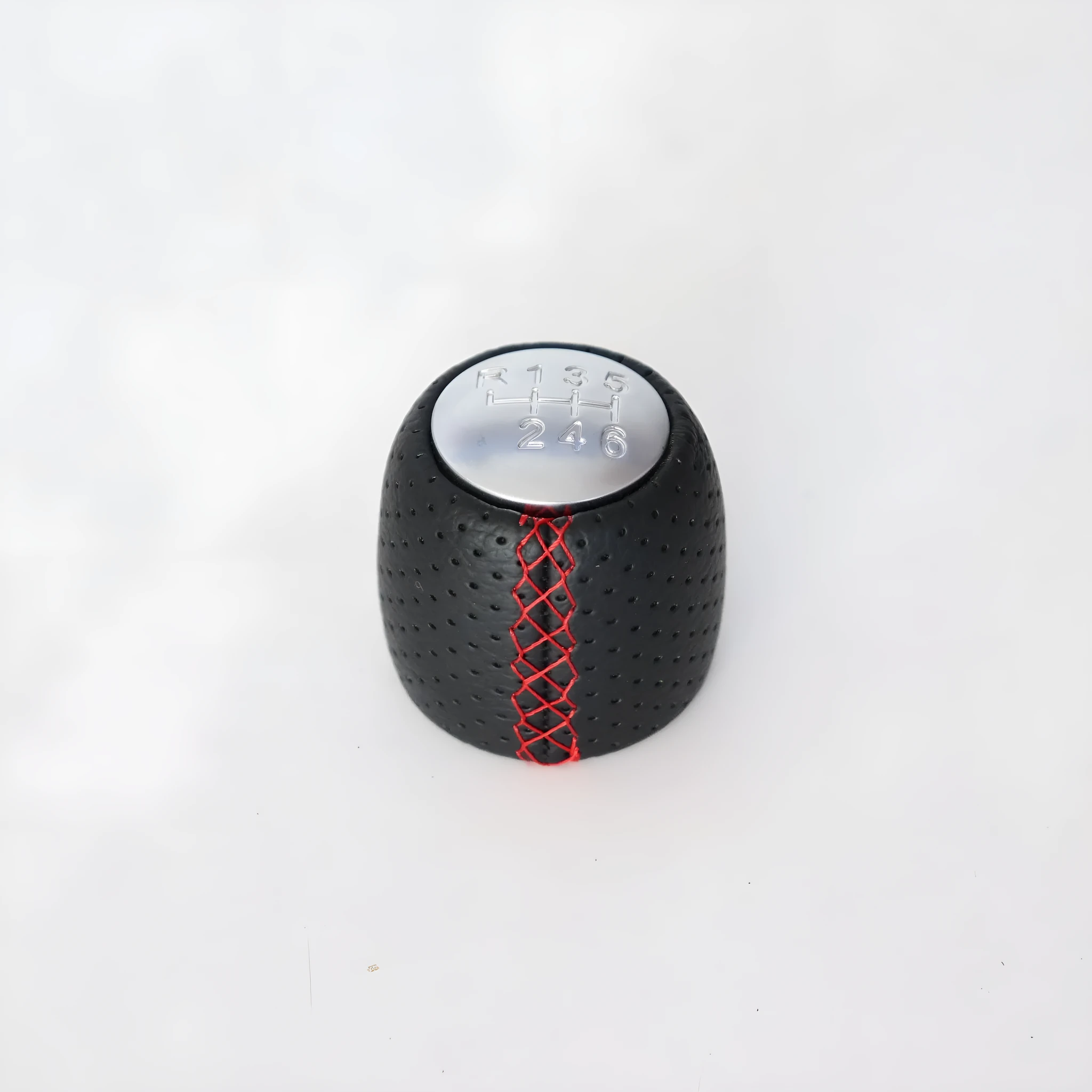 Sewn wrapped perforated leather gear knob for Alpha car in black, red, or white with matte or silver cover.