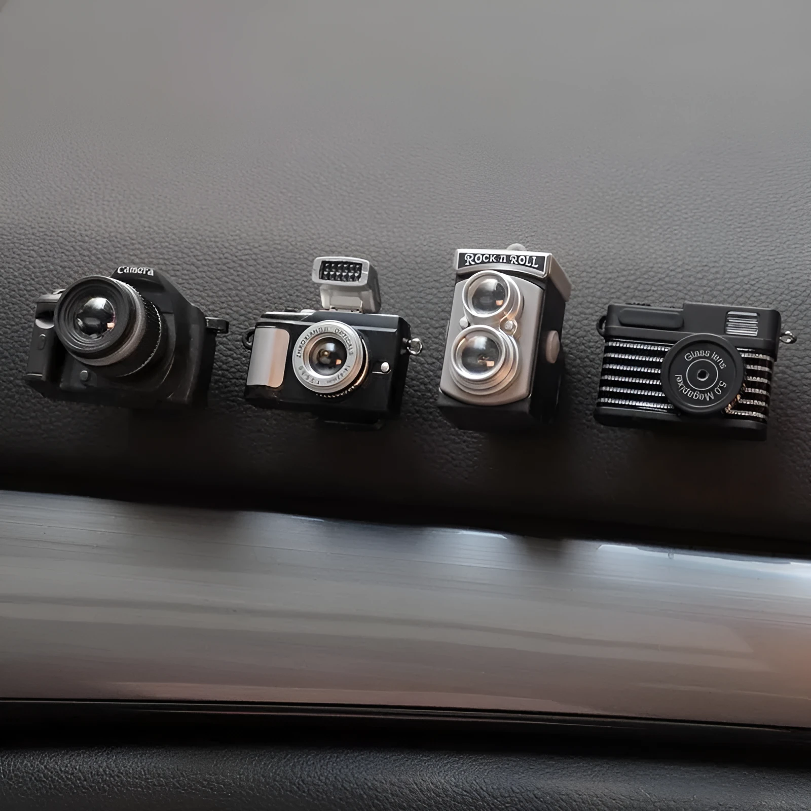 Four retro camera dot design adhesive hooks for car interior organisation measuring 4.2x2.5cm