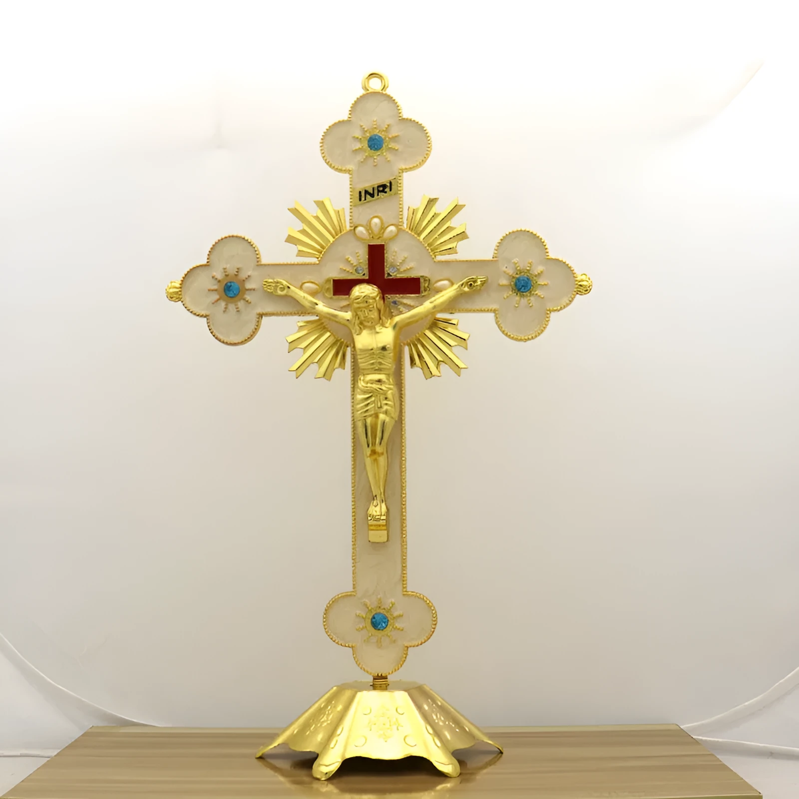 Gold geometric zinc alloy car ornament with micro-inlaid design on a desktop.