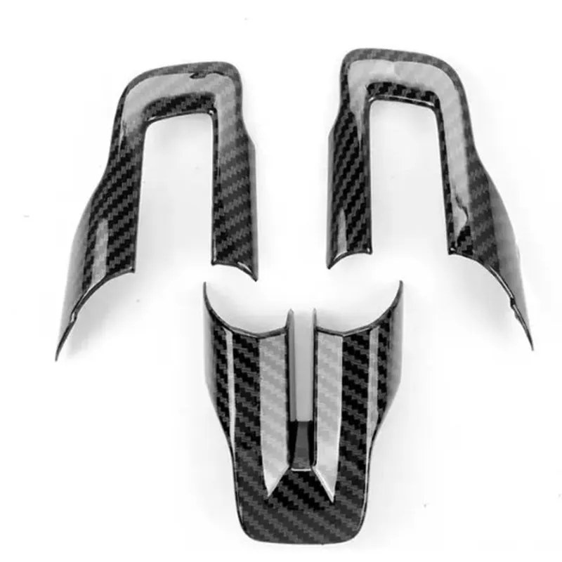 Three-piece ABS plastic car steering wheel decoration set with carbon fibre pattern.