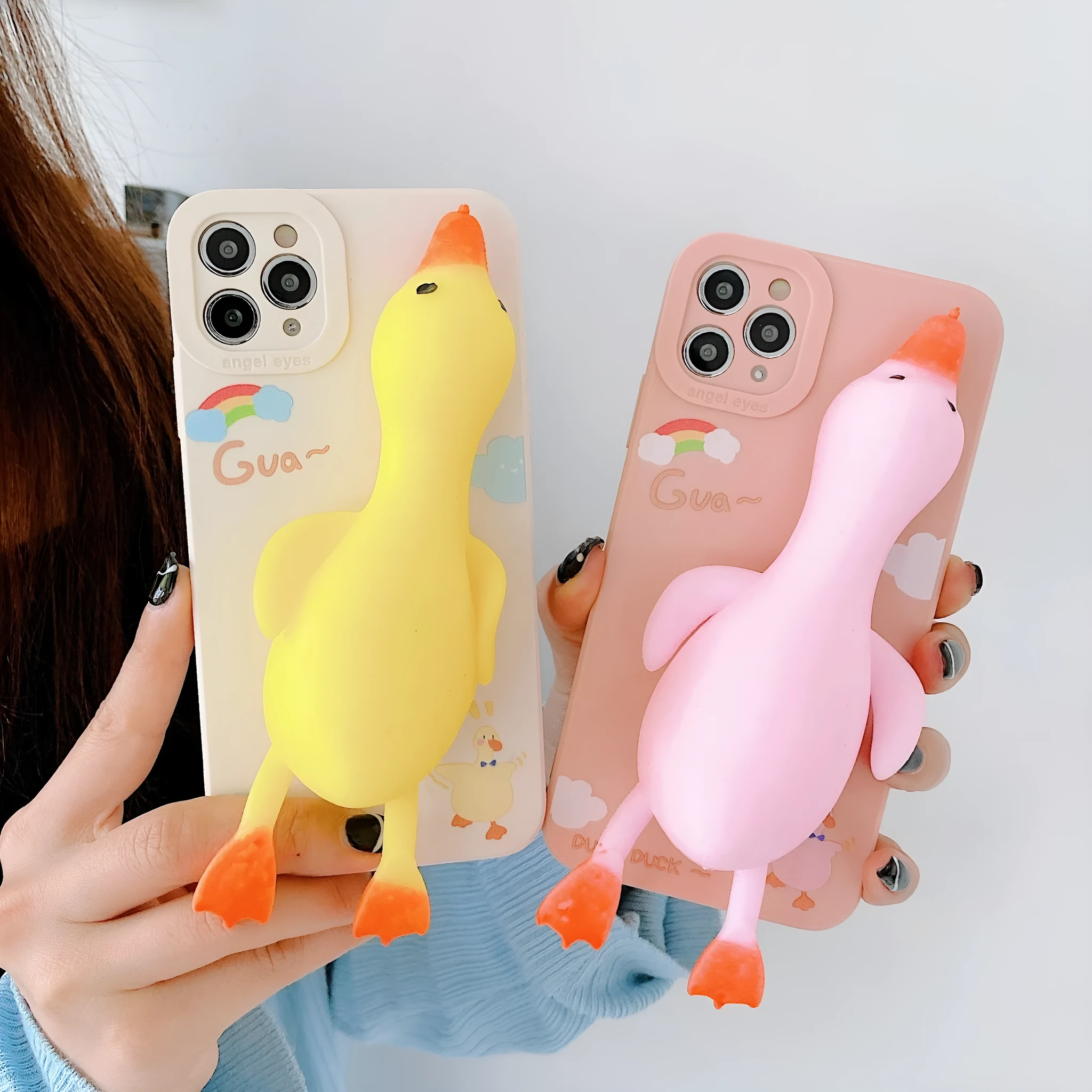 Pinch duck cartoon print silicone protective case for iPhone in yellow, white, or pink.