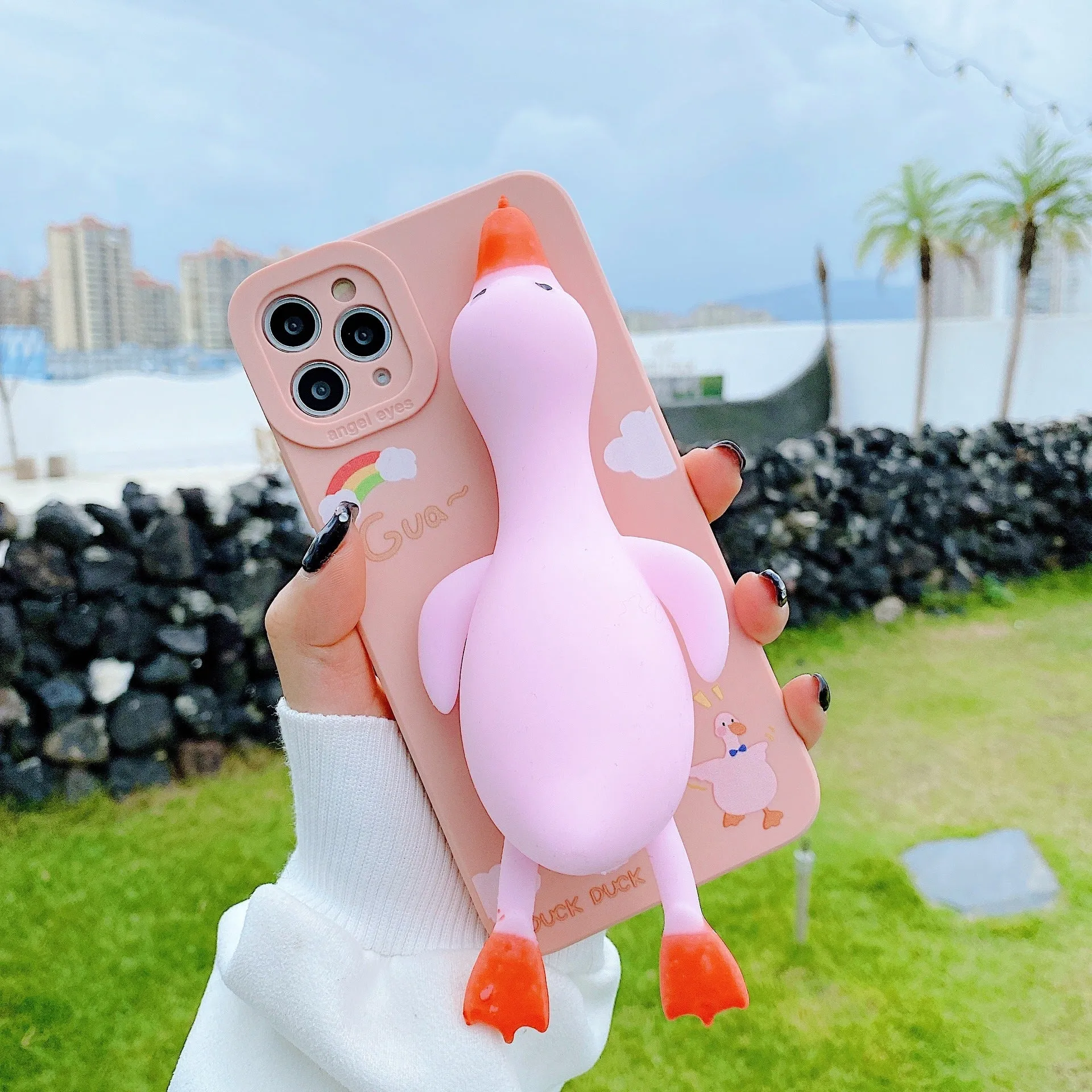 Pinch duck cartoon print silicone protective case for iPhone in yellow, white, or pink.