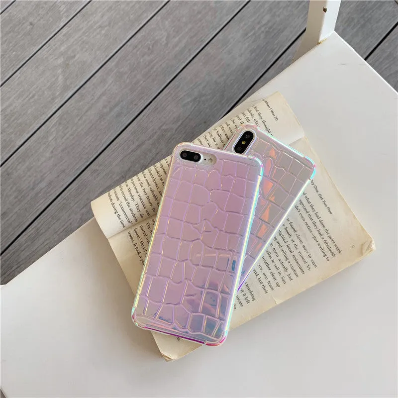 Glossy silver silicone phone case with a laser-etched irregular texture for iPhone, showing raised camera protection.