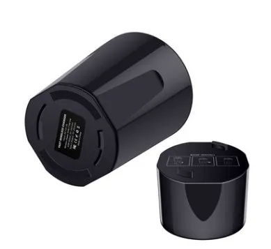Black X9 car wireless charging cup with detachable base on a car dashboard, showing LED light and phone charging.