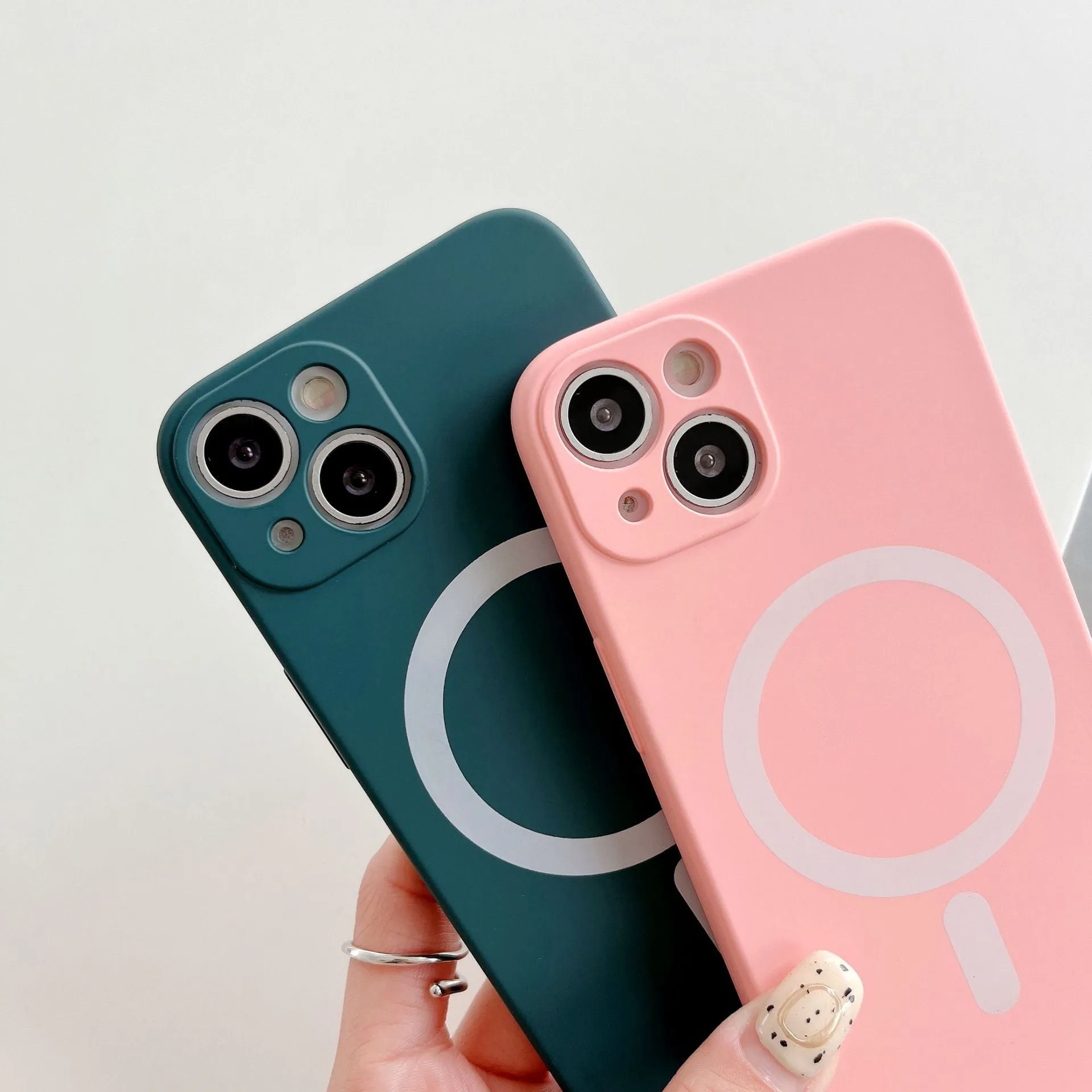 Magnetic wireless charging case for iPhone in various colours including blue, orange, and black.