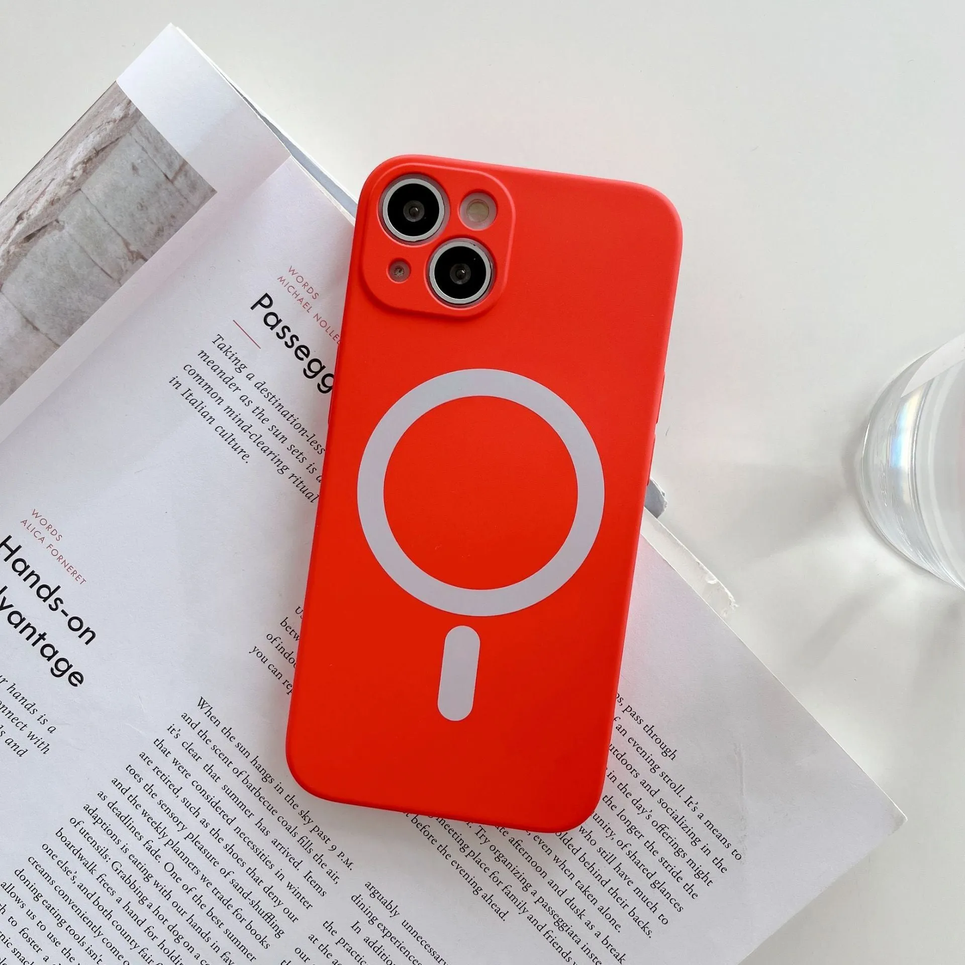 Magnetic wireless charging case for iPhone in various colours including blue, orange, and black.