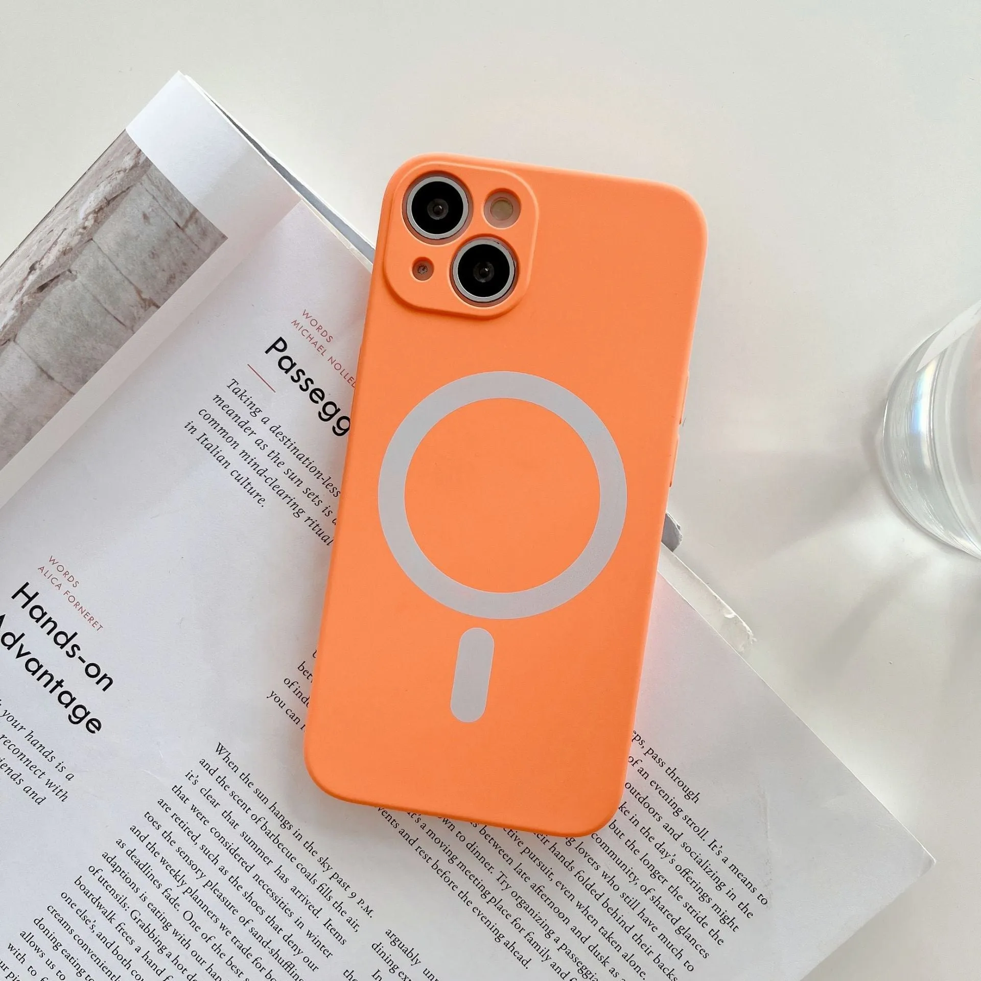 Magnetic wireless charging case for iPhone in various colours including blue, orange, and black.