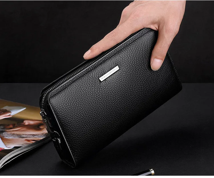 Men's black genuine leather clutch wallet open to show internal card slots, phone pocket, and zippered compartment.