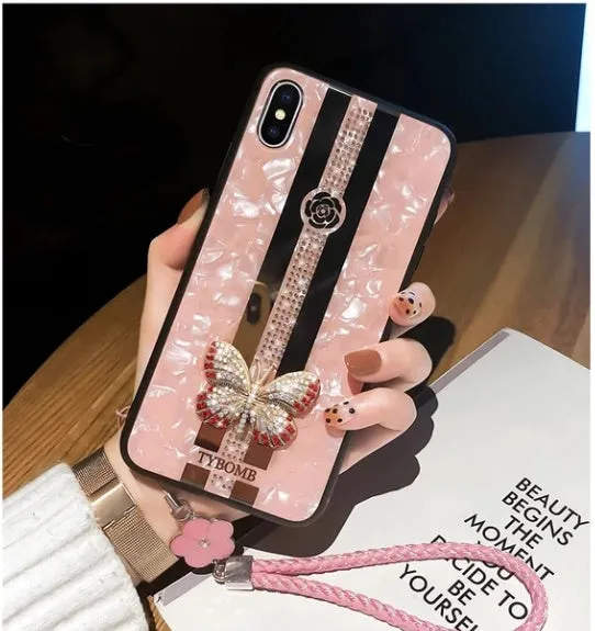 Luxury acrylic iPhone case with butterfly and diamond crystal design and a mirrored back in purple colour.