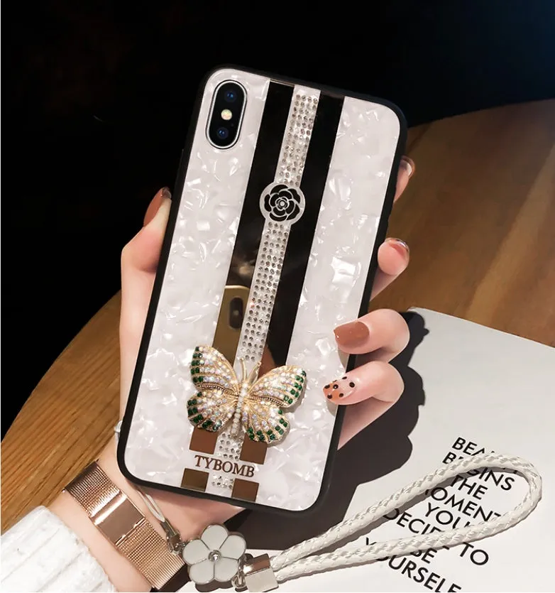 Luxury acrylic iPhone case with butterfly and diamond crystal design and a mirrored back in purple colour.