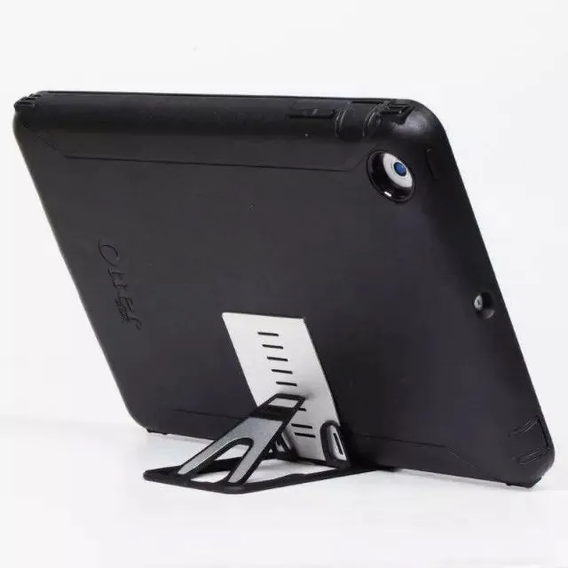 Black card phone holder measuring 8.5cm by 5cm on desktop surface