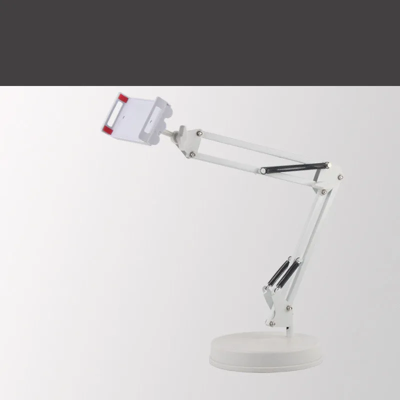 Black universal phone stand with long rotating metal arm and heavy circular base on a wooden desk.