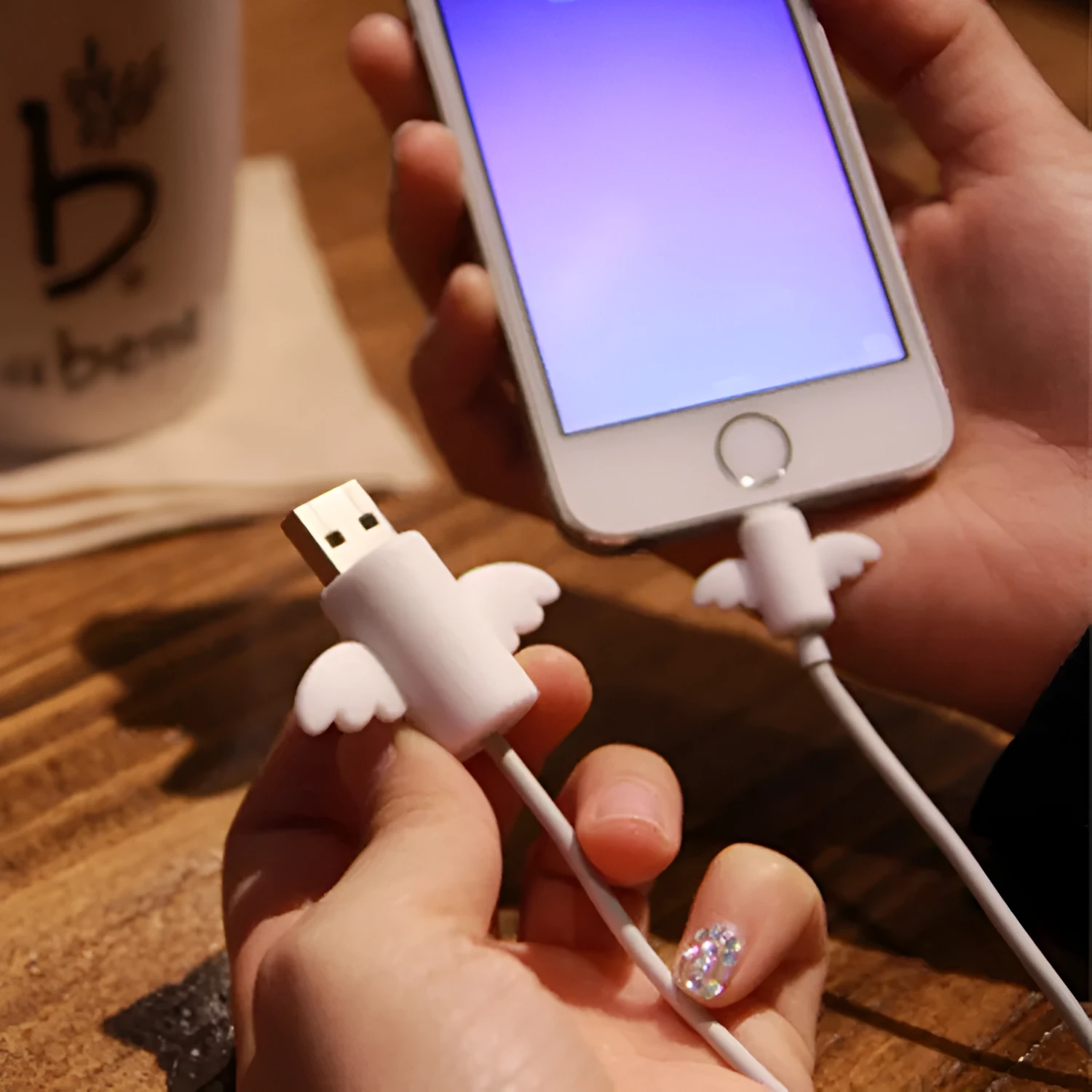 White Angel and black Bat design silicone protective covers for mobile phone charging cables in two sizes.