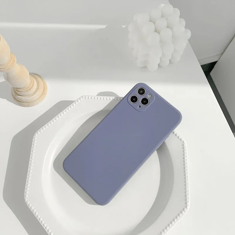 Simple solid colour silicone iPhone case in powder blue on a table.