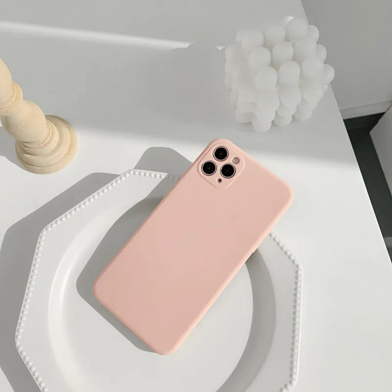 Simple solid colour silicone iPhone case in powder blue on a table.