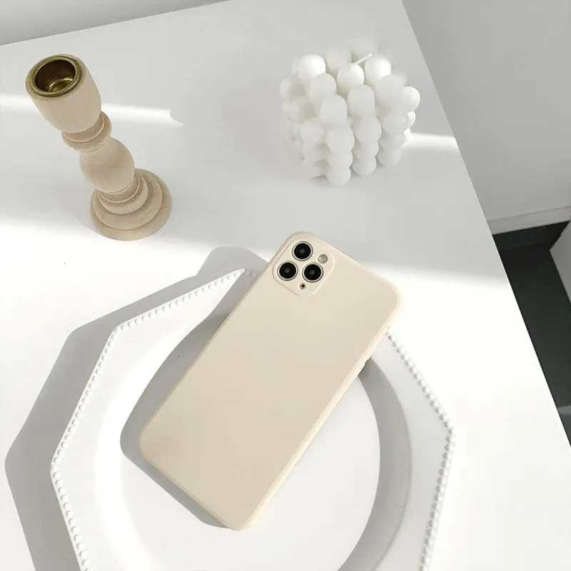 Simple solid colour silicone iPhone case in powder blue on a table.