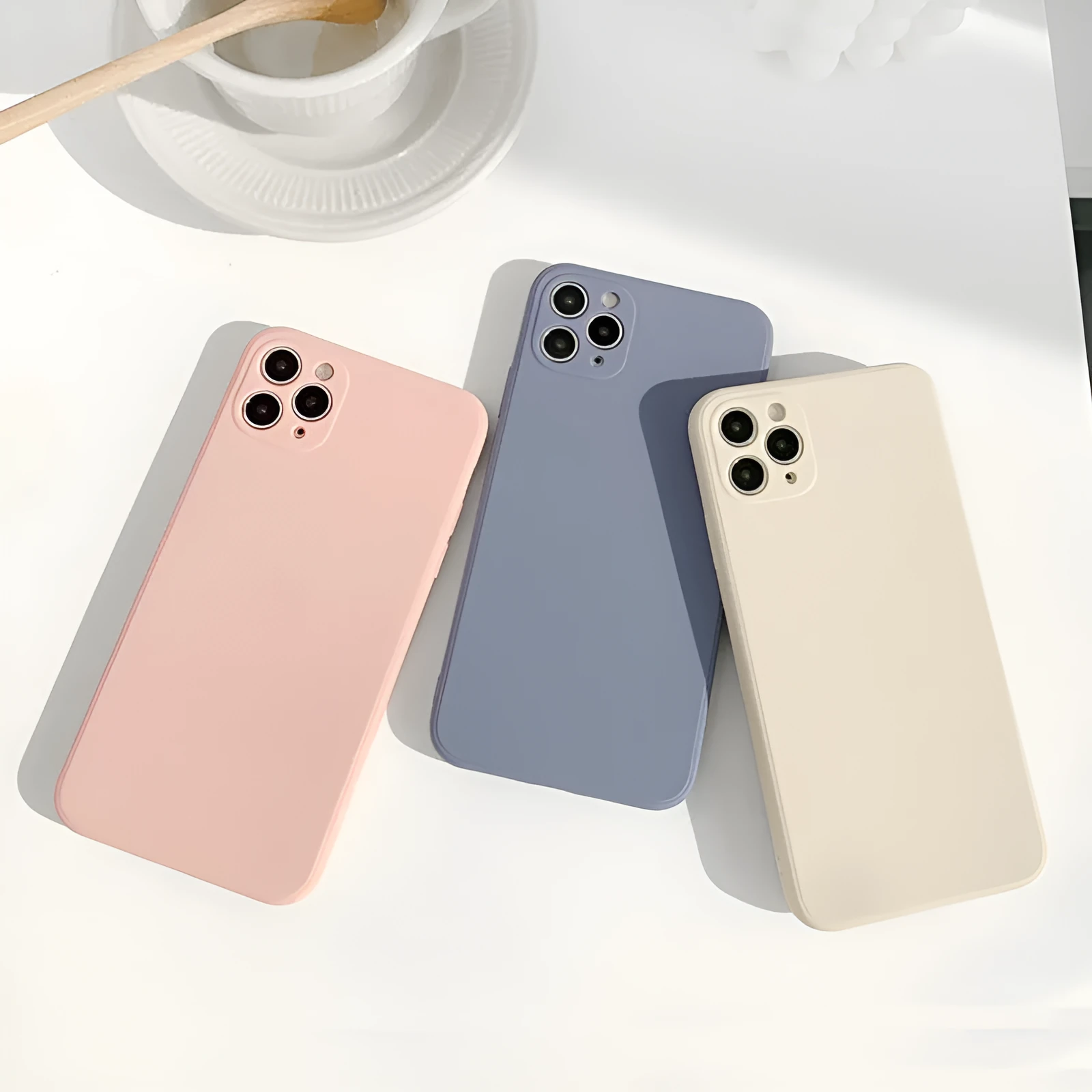 Simple solid colour silicone iPhone case in powder blue on a table.