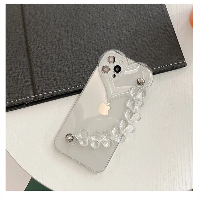Clear iPhone case with a red love heart and chain design on the back