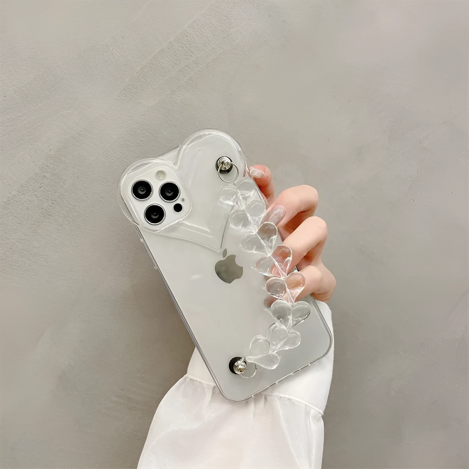 Clear iPhone case with a red love heart and chain design on the back