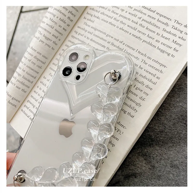 Clear iPhone case with a red love heart and chain design on the back