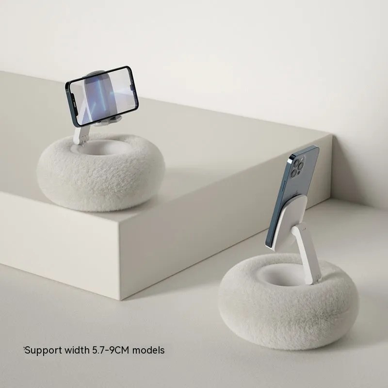 Adjustable rotating phone and tablet bracket on a desk, showing the clamp and fabric base.