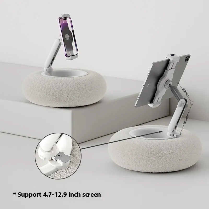 Adjustable rotating phone and tablet bracket on a desk, showing the clamp and fabric base.