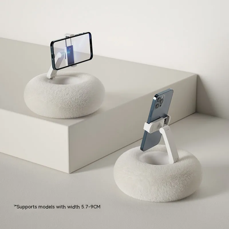 Adjustable rotating phone and tablet bracket on a desk, showing the clamp and fabric base.