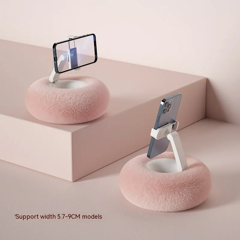 Adjustable rotating phone and tablet bracket on a desk, showing the clamp and fabric base.