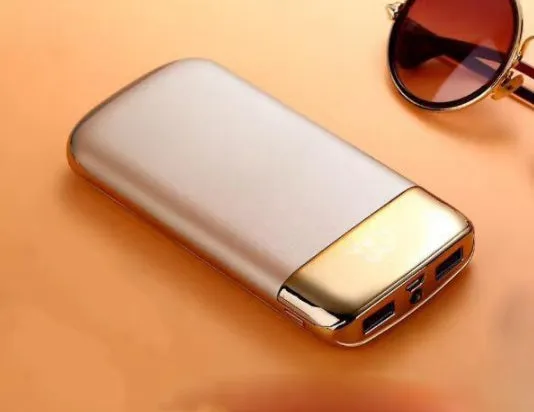 Y10 black portable power bank with LCD display showing battery percentage, two USB ports, and an LED light.