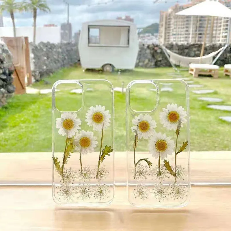 Clear TPU iPhone case with white epoxy daisy floral pattern on the back.