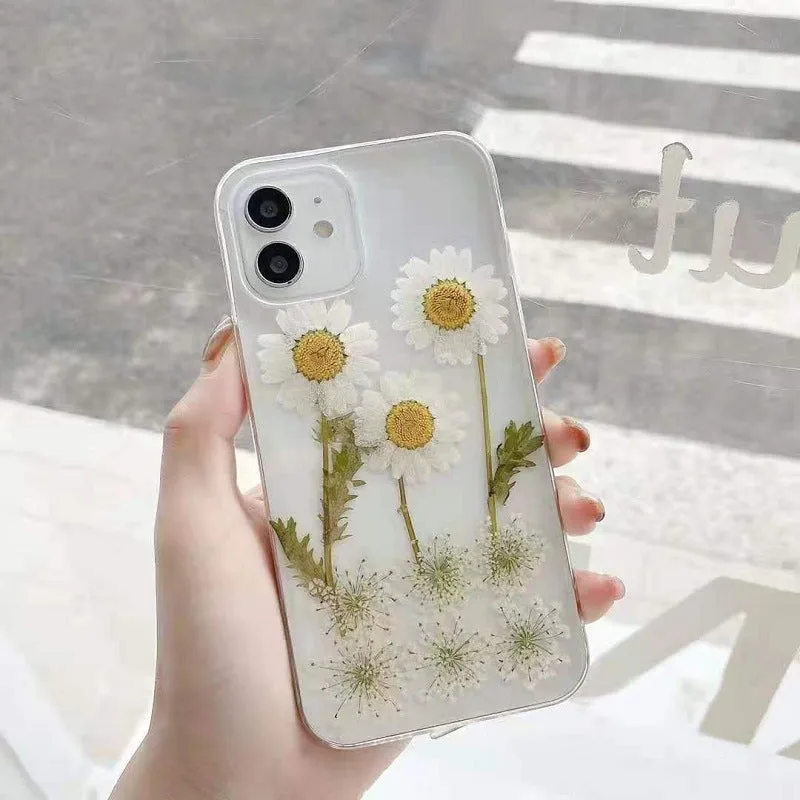 Clear TPU iPhone case with white epoxy daisy floral pattern on the back.