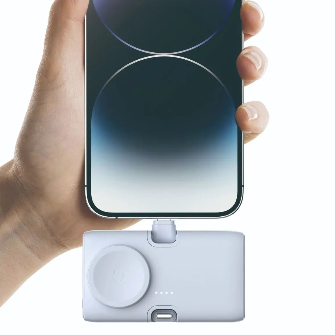 Compact white wireless power bank with 5000mAh capacity, shown next to a mobile phone for scale.