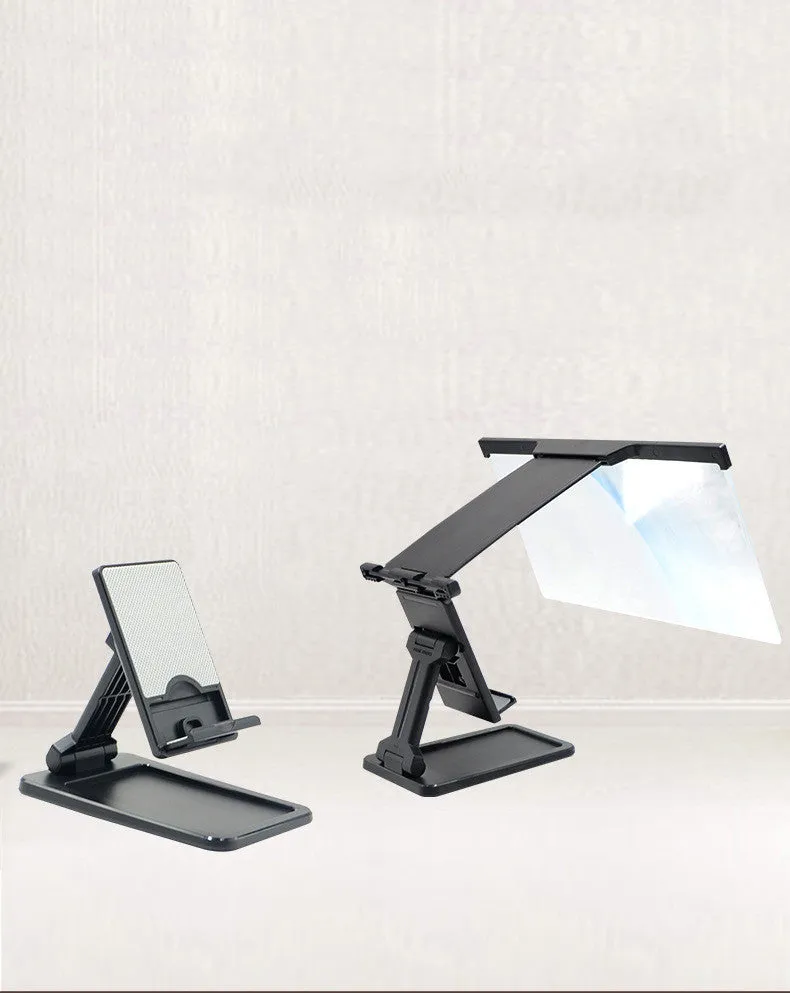 Black folding mobile phone screen amplifier with detached phone holder on a desk