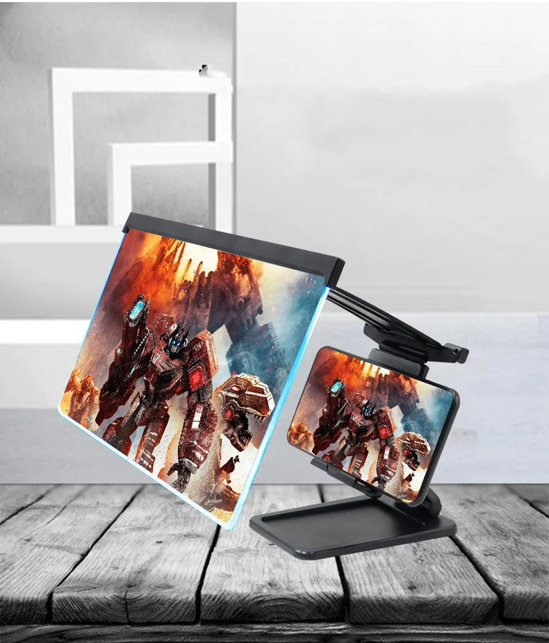 Black folding mobile phone screen amplifier with detached phone holder on a desk