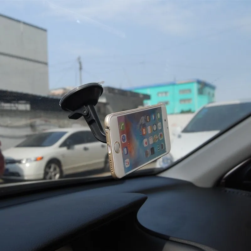 Black magnetic car phone holder with 360 rotation for dashboard mounting with iPhone and Samsung compatibility