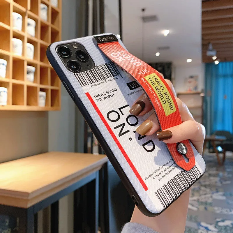 Red TPU+PC iPhone back cover case with a black wristband attached, lying on a white surface.