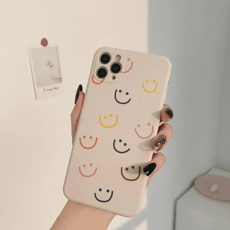 Simple silicone TPU iPhone case with a painted smiley face design on a solid colour background.