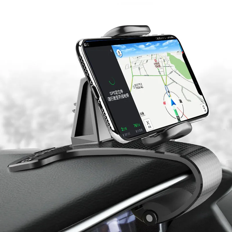 Black universal car phone mount with 360-degree rotating head on a car dashboard.