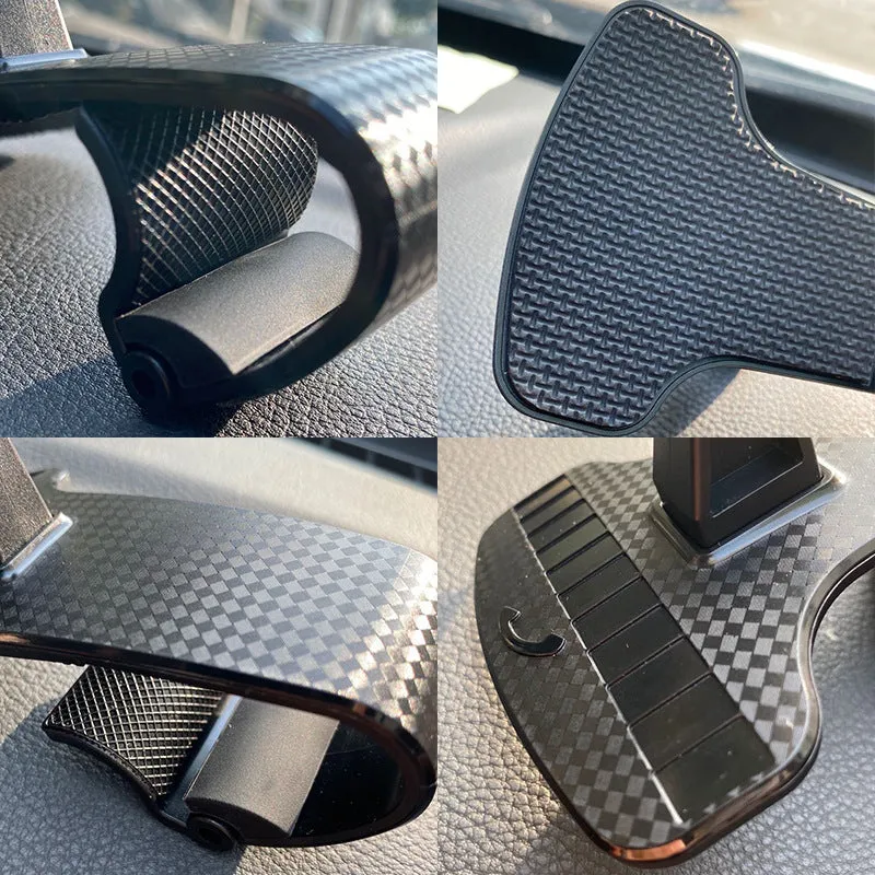 Black universal car phone mount with 360-degree rotating head on a car dashboard.
