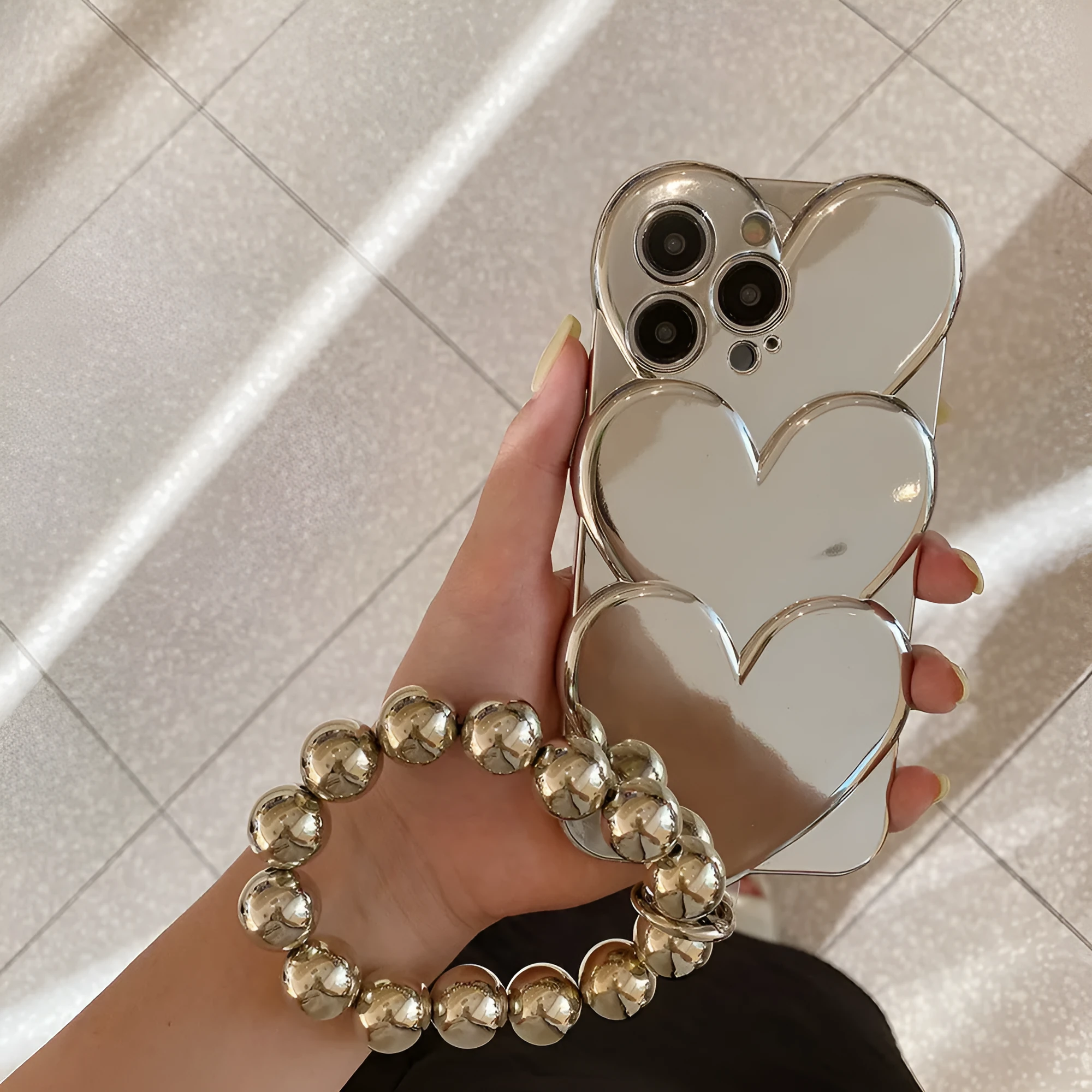 Soft TPU iPhone case with a silver three-dimensional love electroplating design on the back.