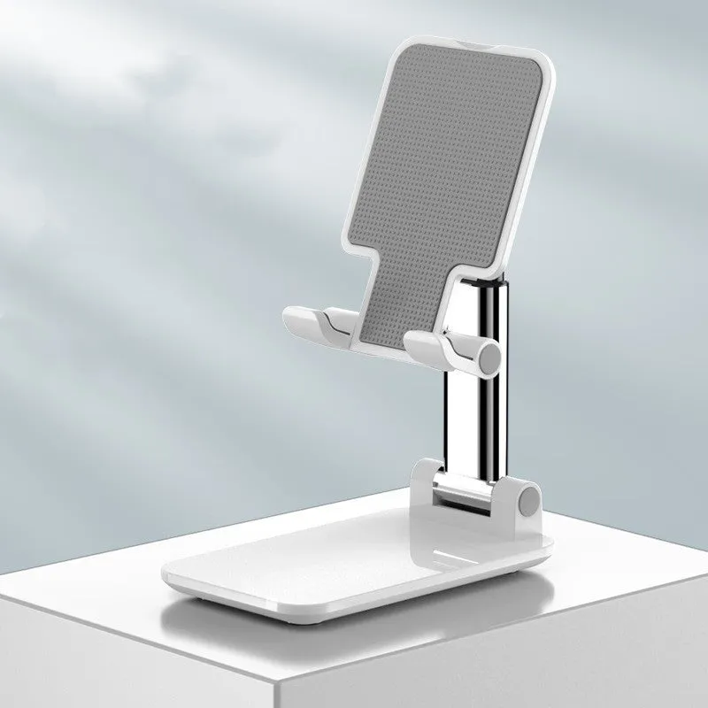 Folding telescopic mobile phone bracket in white, blue, green, or pink colours on a desktop.